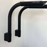 Pair of vintage wall lights, tubular and perforated black metal, Parscot France 1980