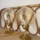 2 bedside lamps with round amber glass globes and gold metal.