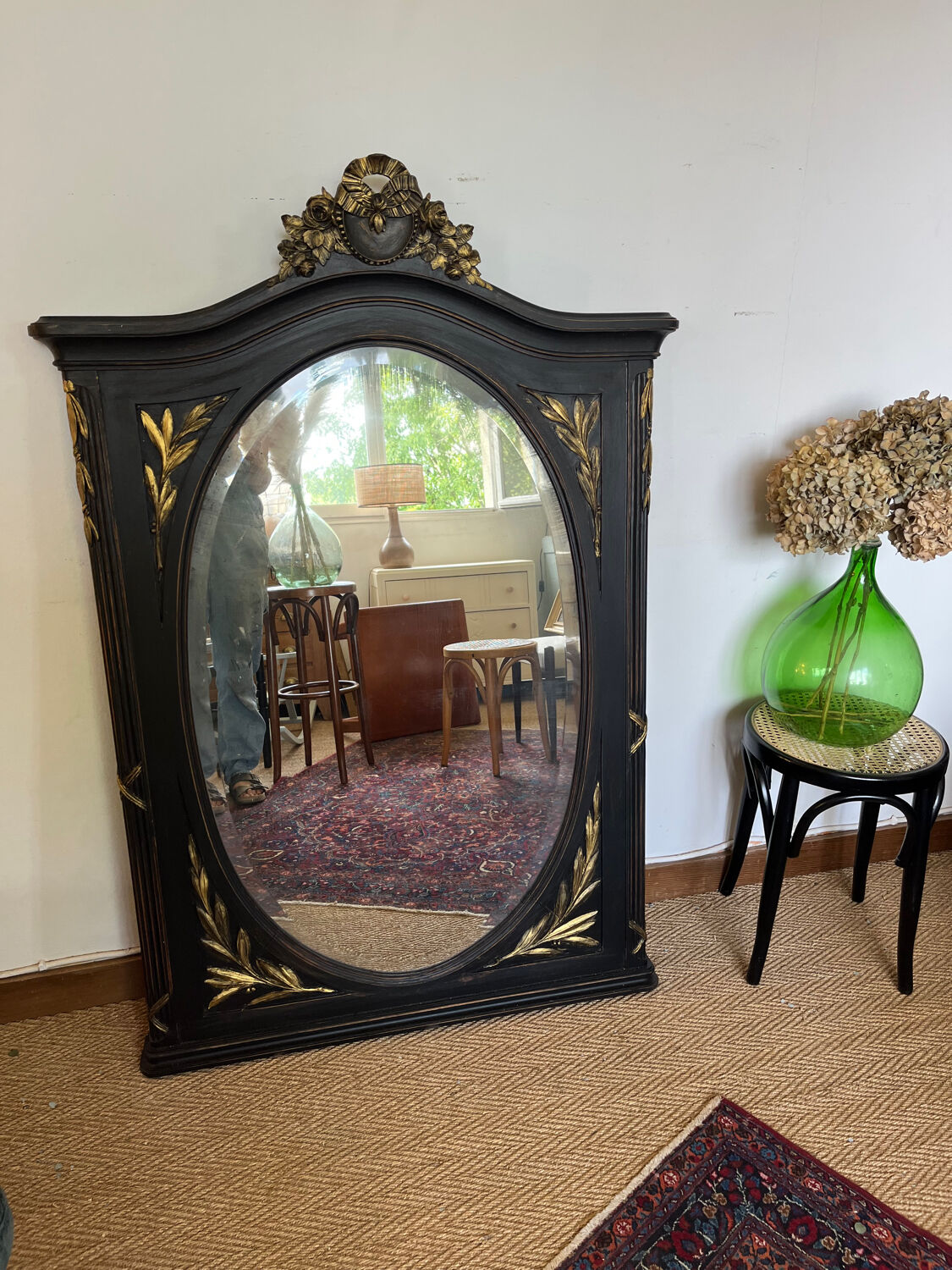 Large old trumeau mirror in black and gilded wood Napoleon style