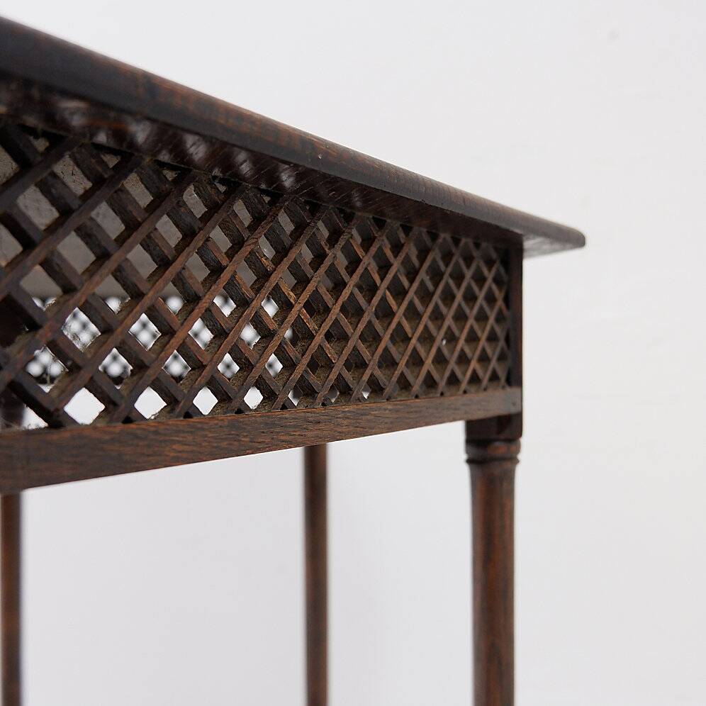 Hexagonal pedestal table or side table with a lattice structure and star pattern.