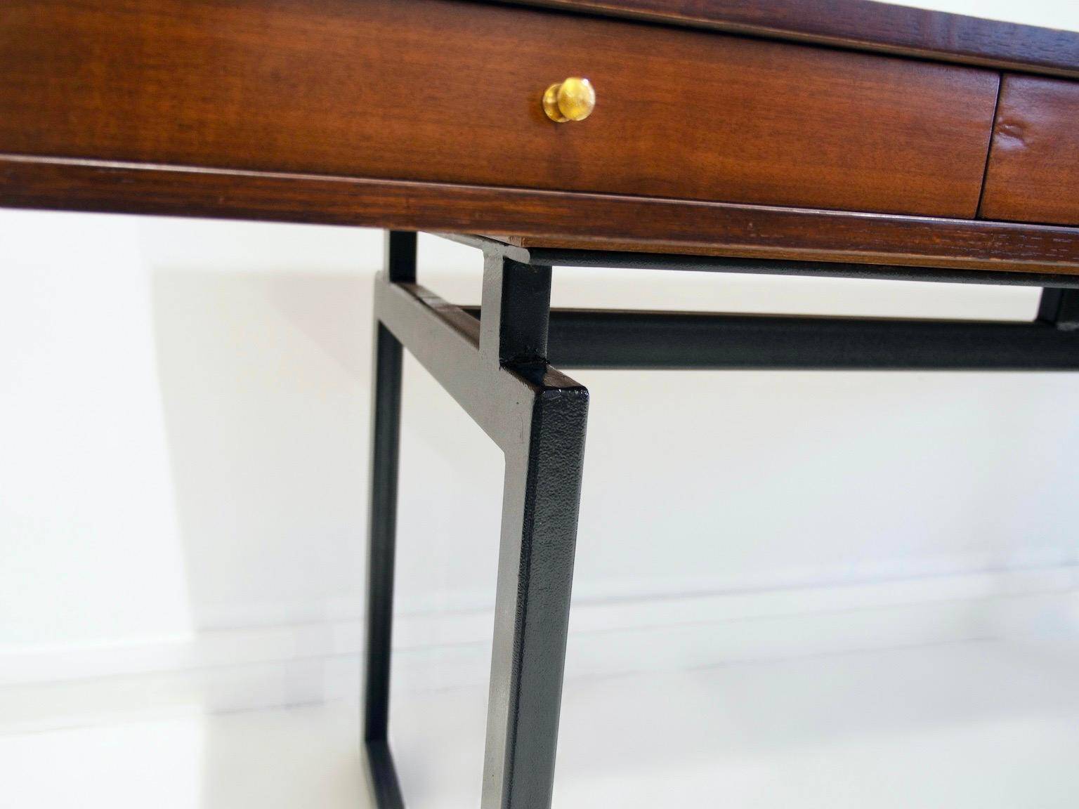 Wooden desk with drawers and black lacquered legs.