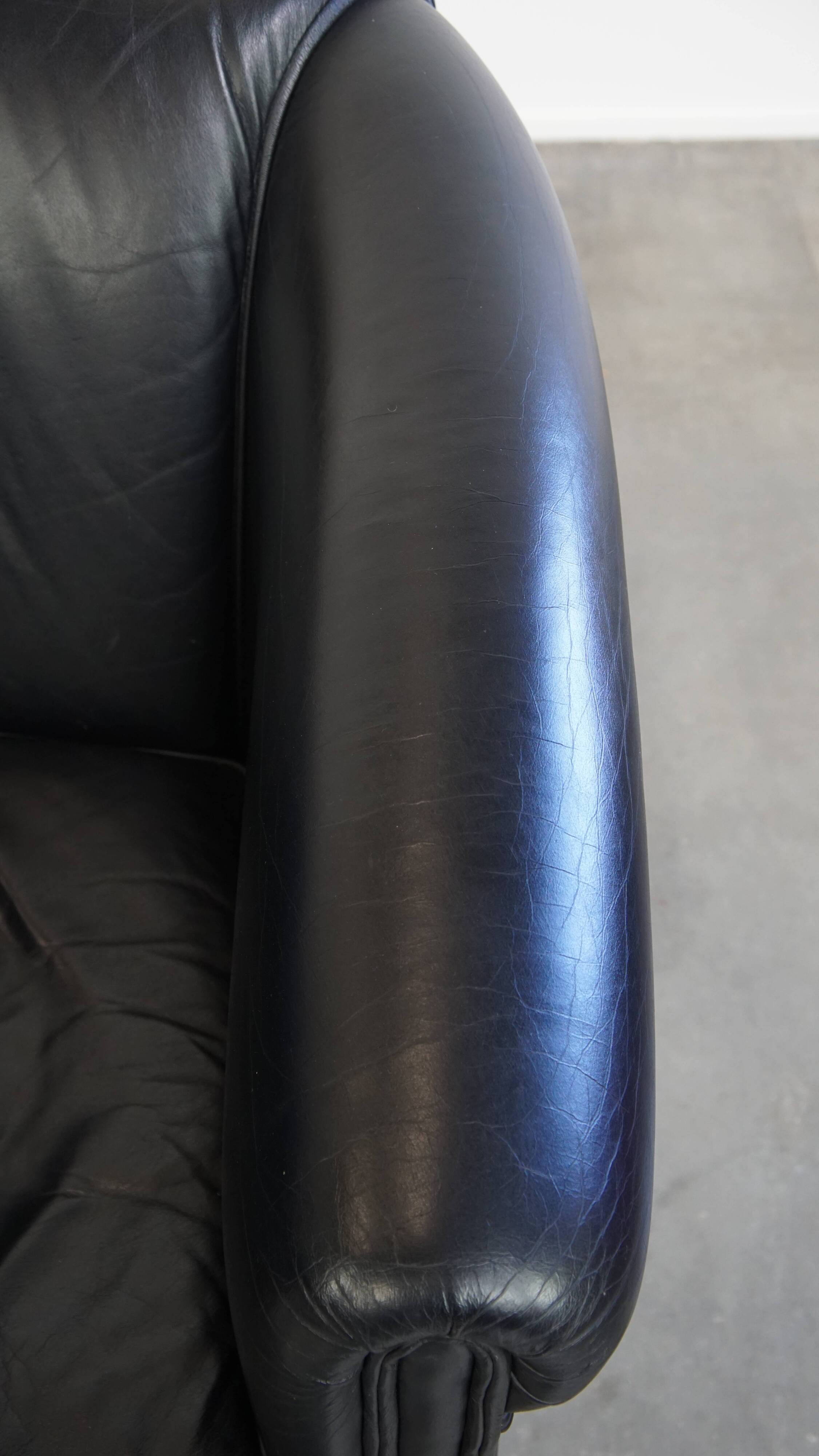 Black cowhide club chair in English style with a great luxurious design