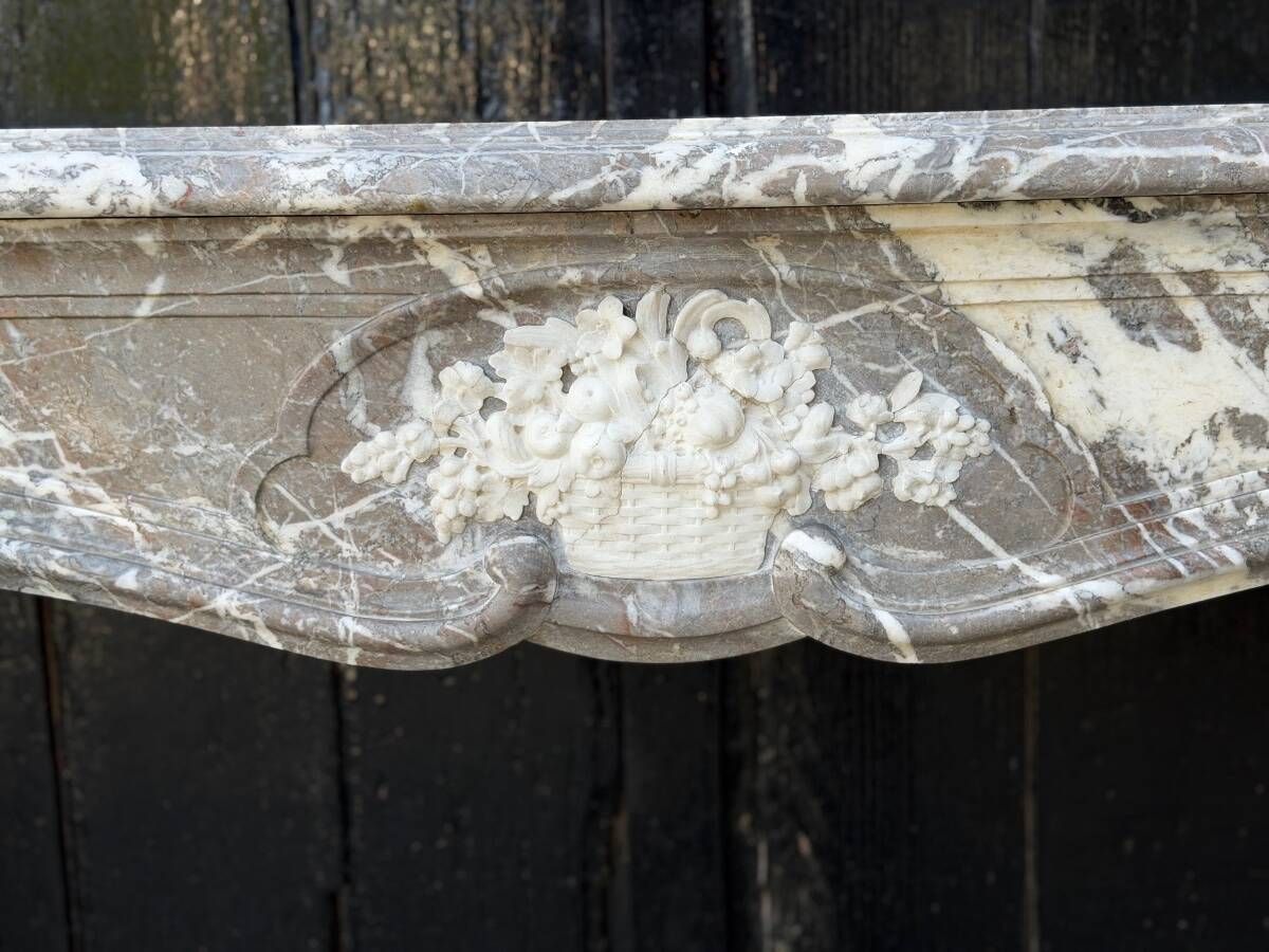 Louis XV fireplace in grey Ardennes marble, a floral basket in white marble, late 18th century.