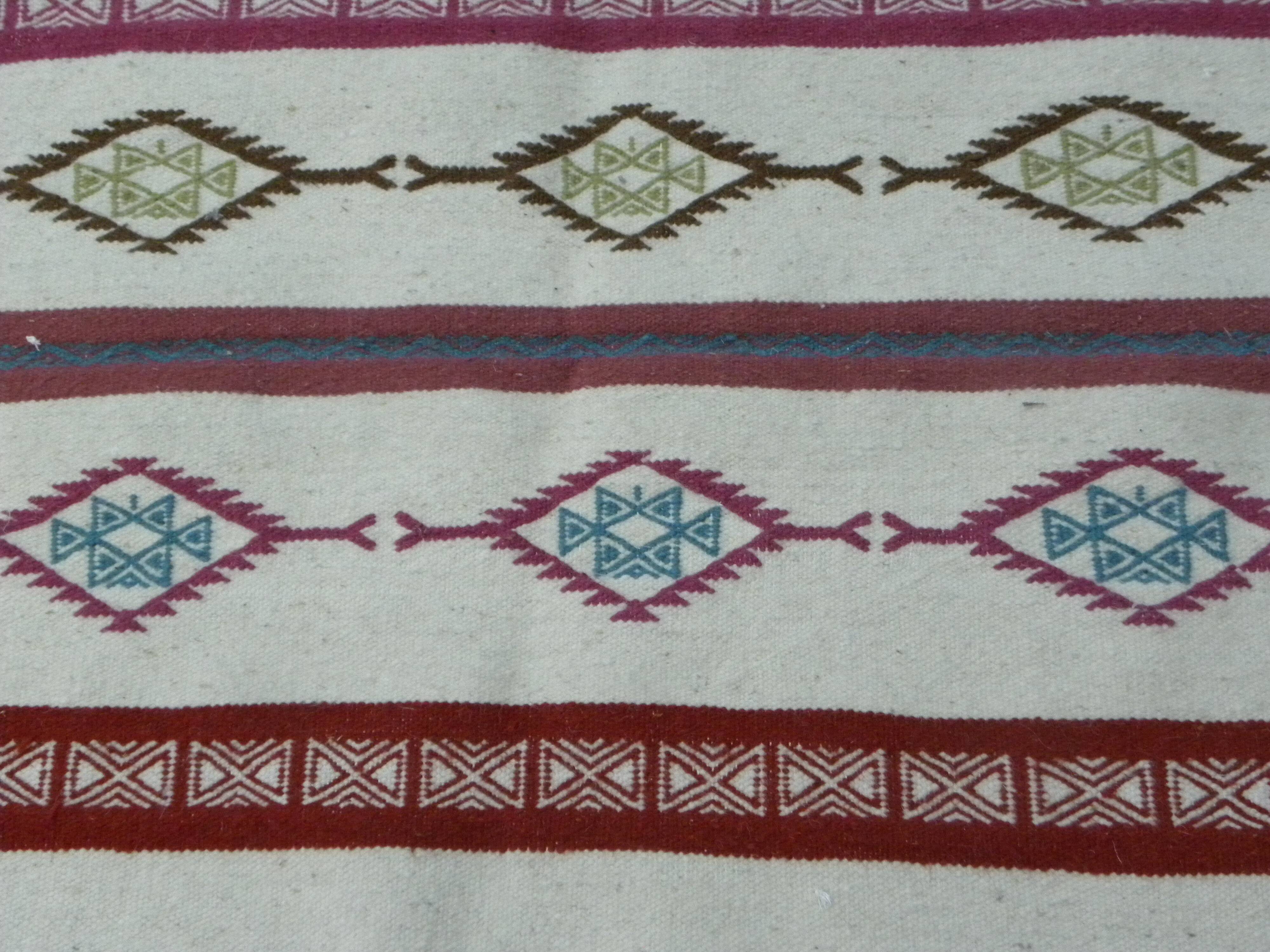 Tribal bohemian kilim rug with geometric pattern in wool.
