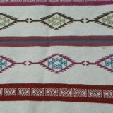 Tribal bohemian kilim rug with geometric pattern in wool.