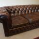 Vintage three-seater brown leather Chesterfield sofa