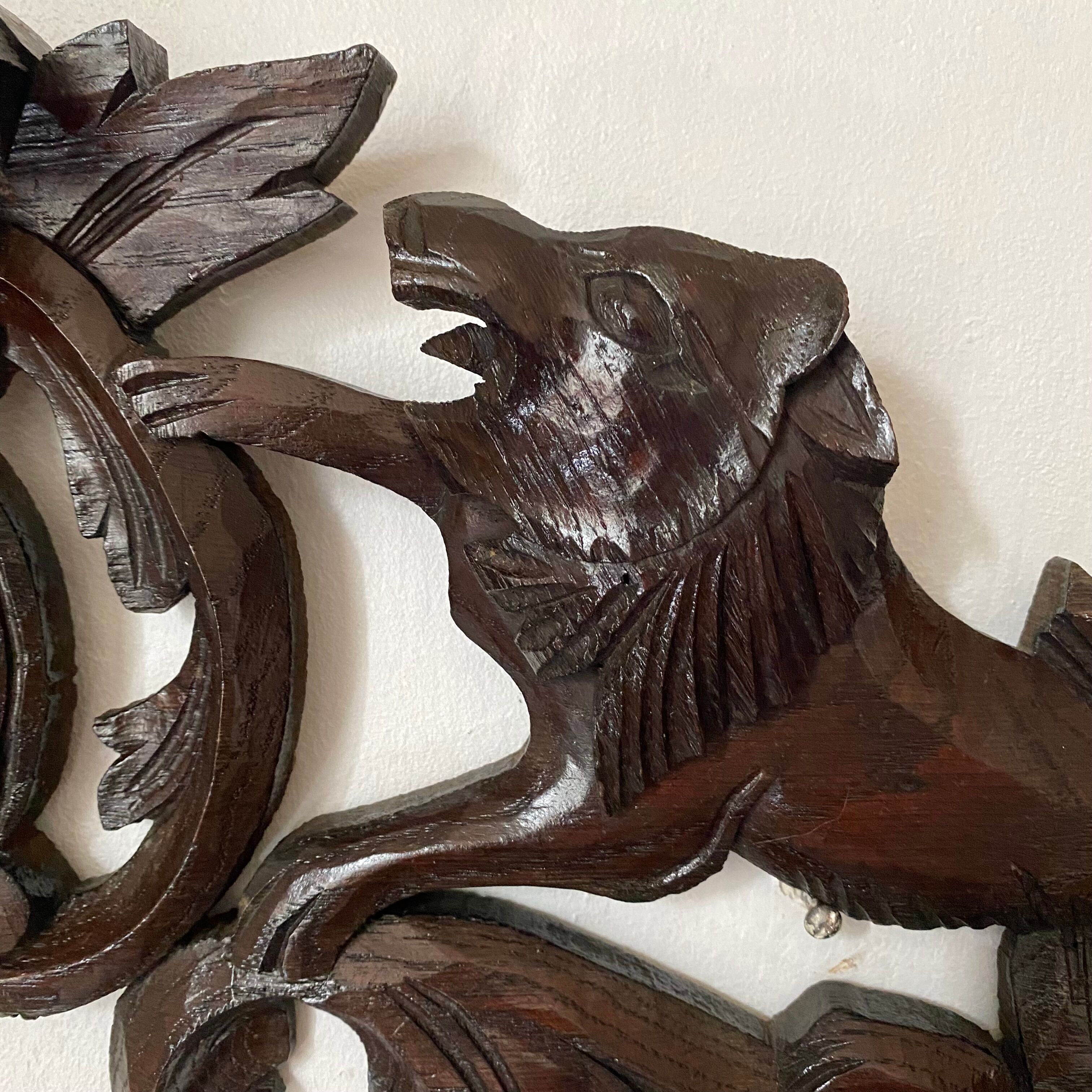 Antique carved wooden pediment with lions and medallion