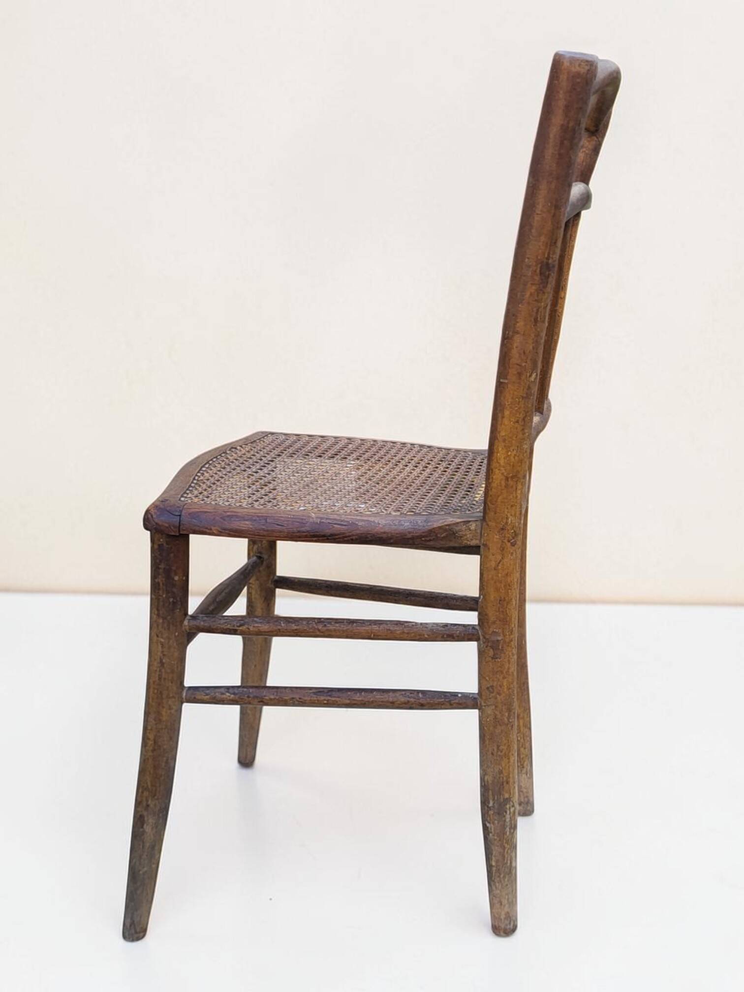 Chair with a slatted backrest and caned seat.
