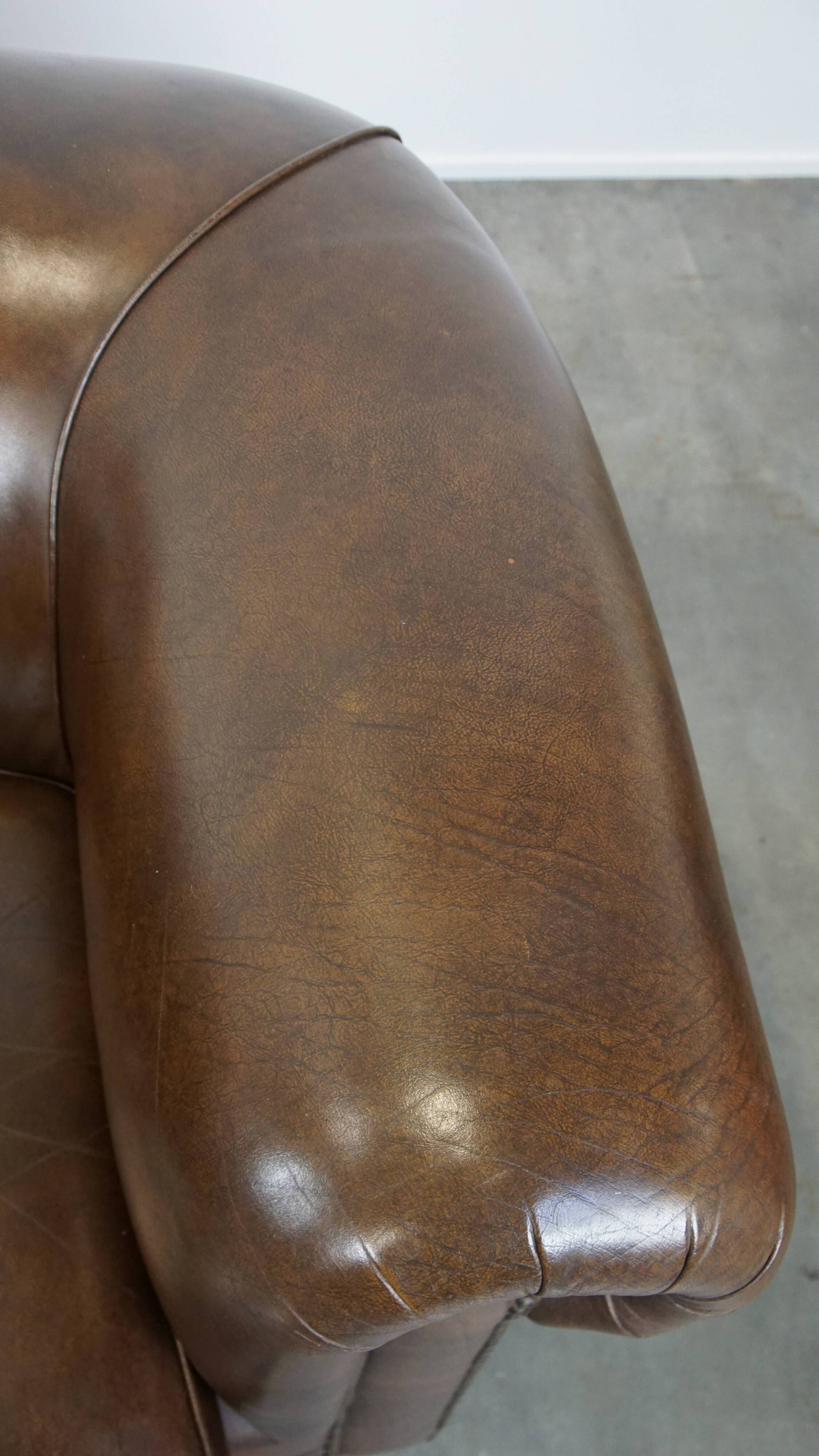 2 Chesterfield armchairs in dark brown cowhide