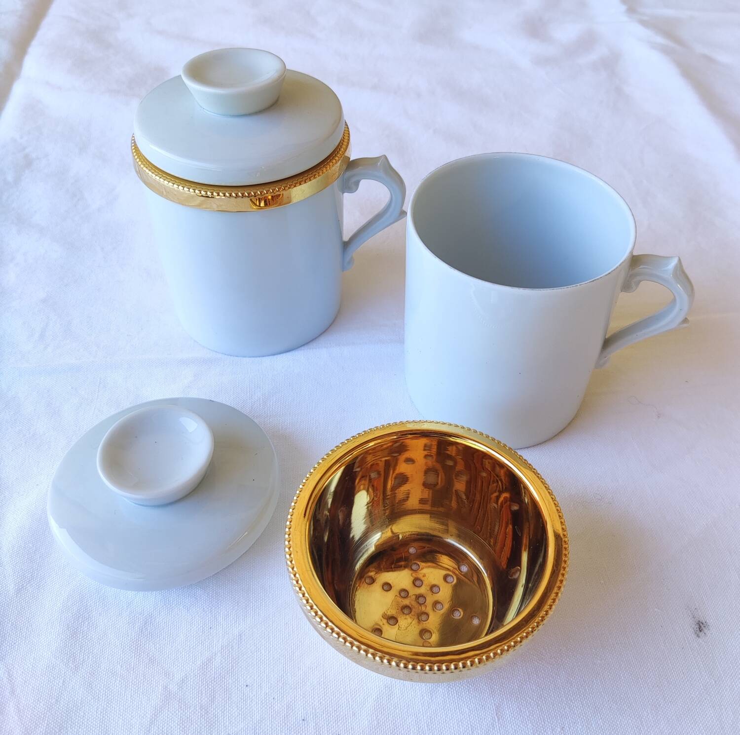 2 white and gold Limoges porcelain tea cups