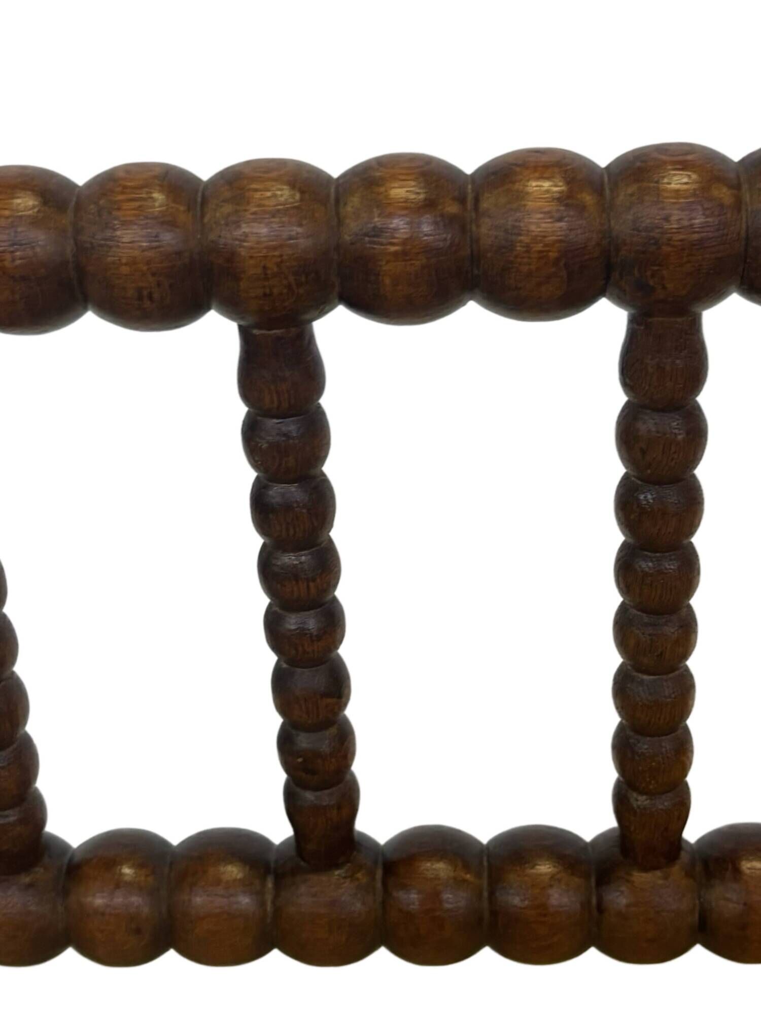 Vintage 'bobbin' bench with a rush seat, 1920s design with armrests.