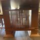 "Frank Lloyd Wright set with a table and its eight chairs."