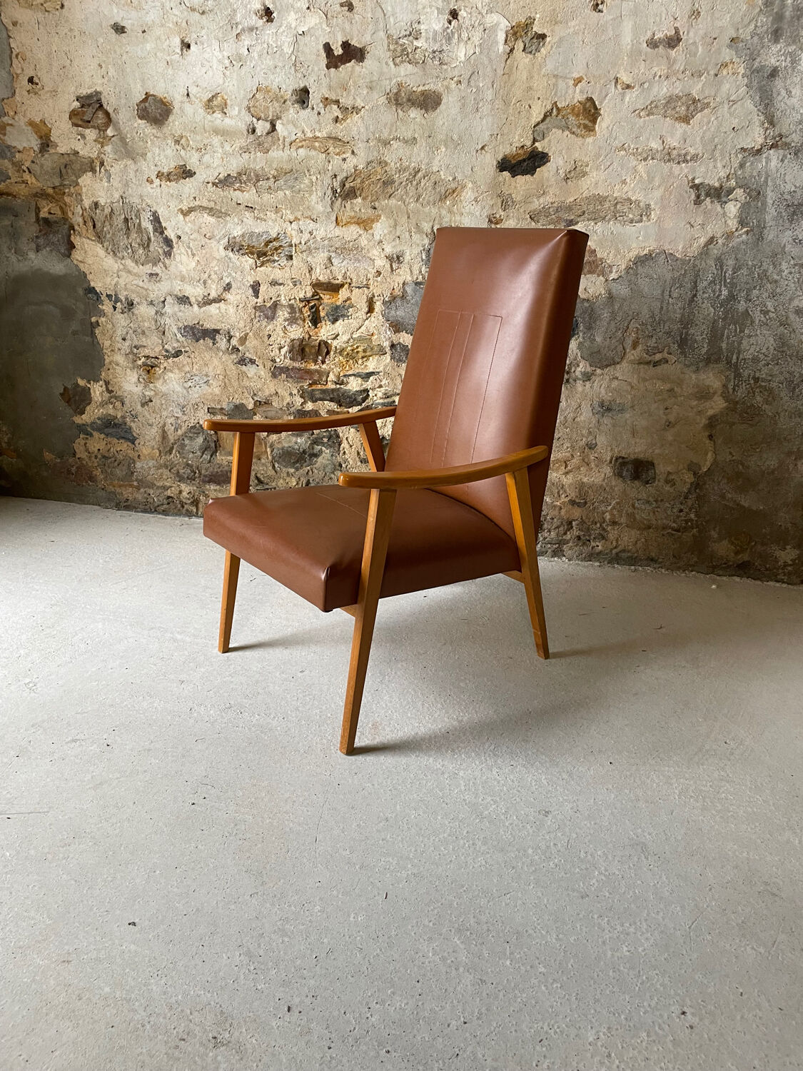 Vintage armchair in wood and brown faux leather
