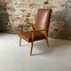 Vintage armchair in wood and brown faux leather