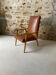 Vintage armchair in wood and brown faux leather