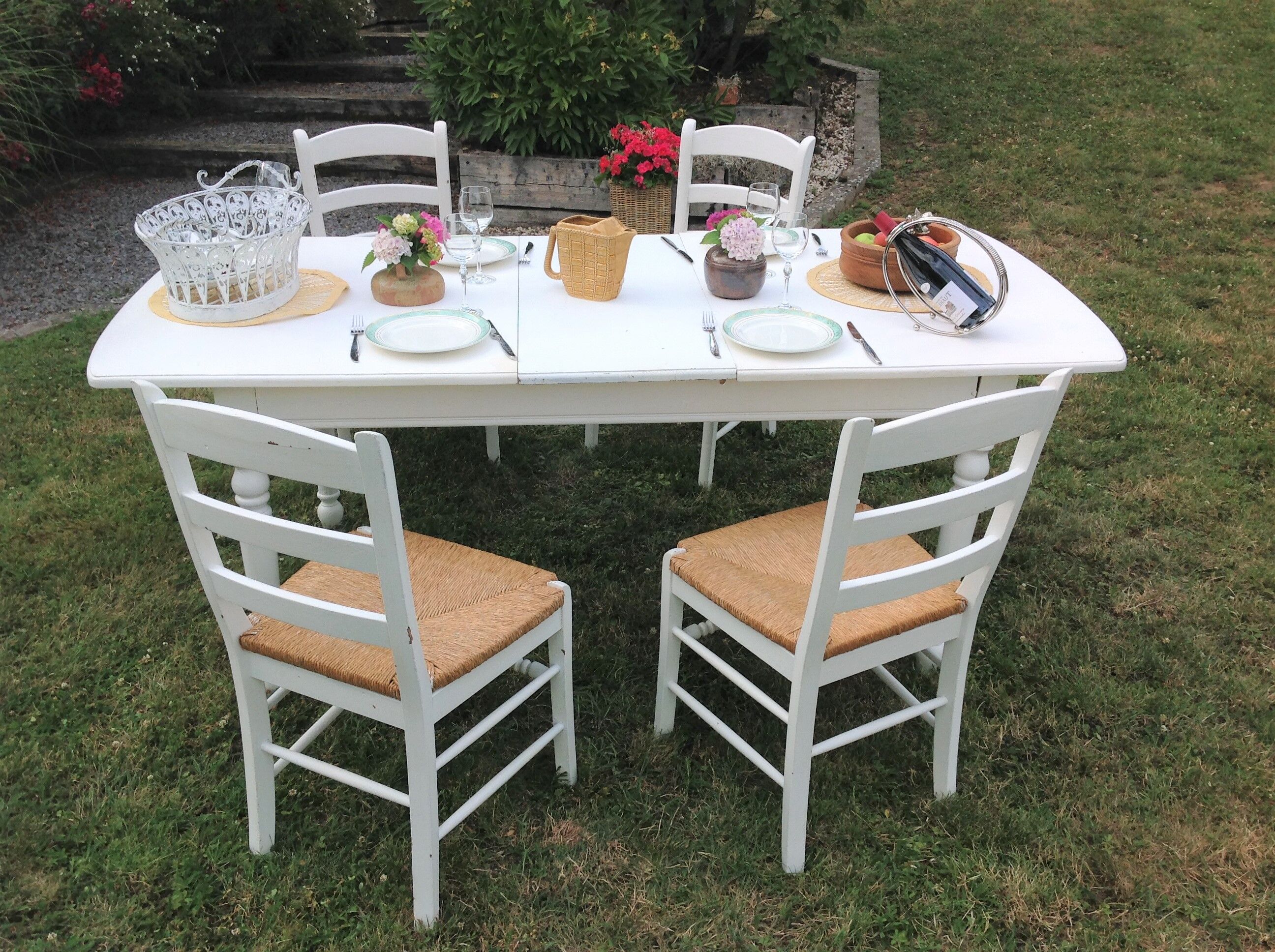 White farmhouse table set and four chairs