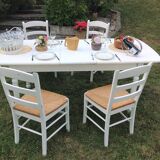 White farmhouse table set and four chairs