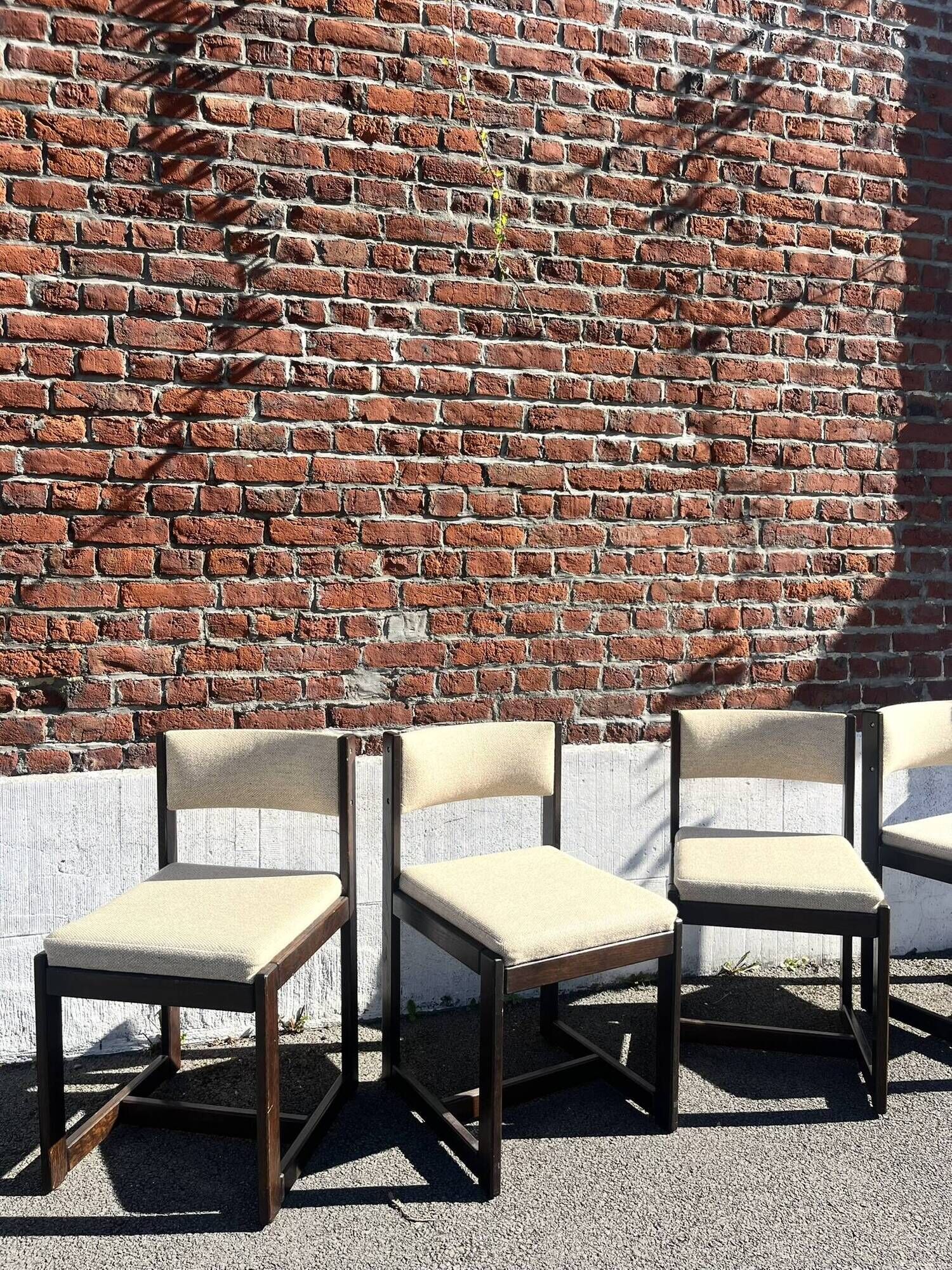 Many mid-century vintage wooden and fabric chairs.