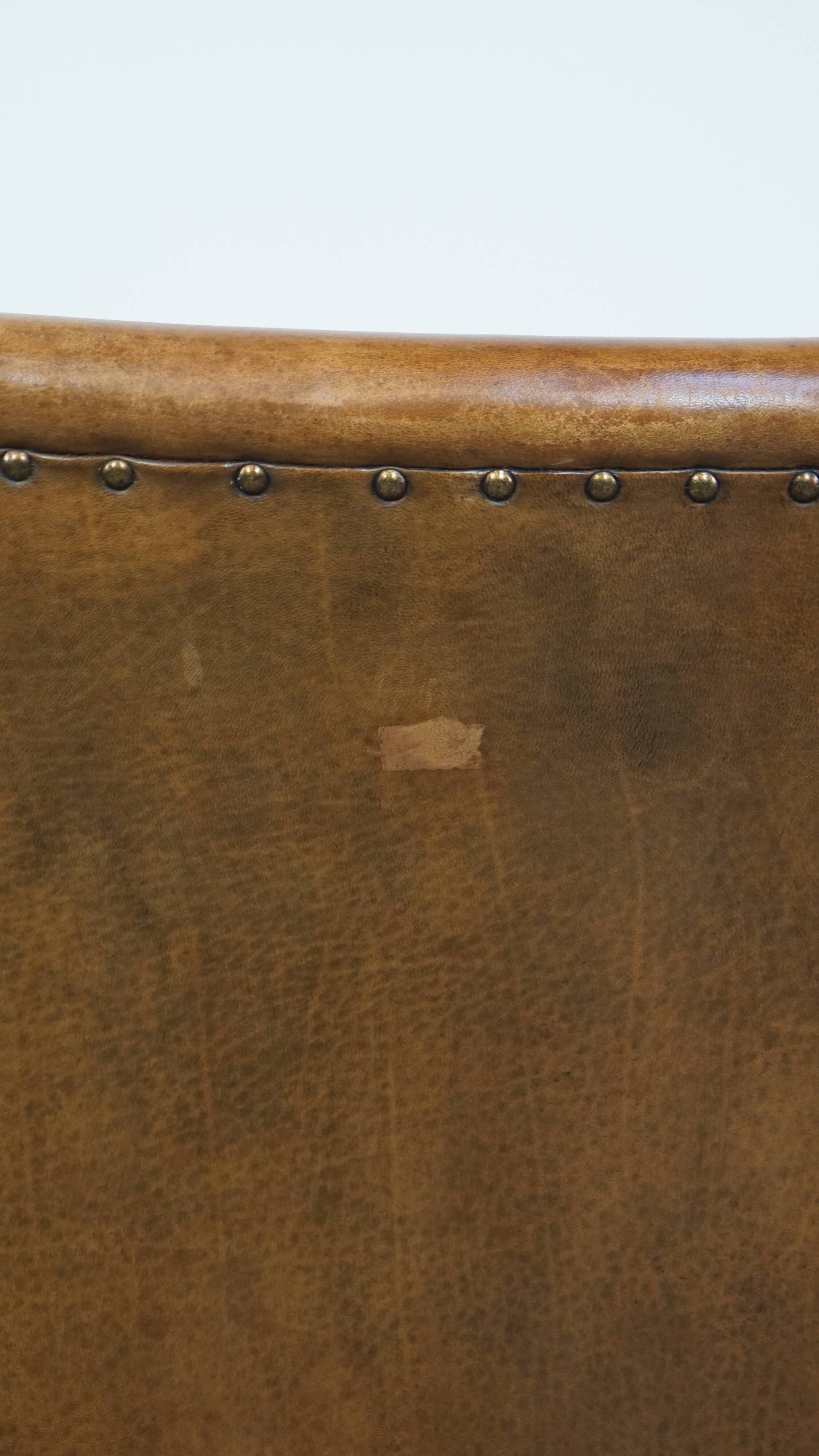 Cognac-colored sheepskin and wooden Art Deco design armchair