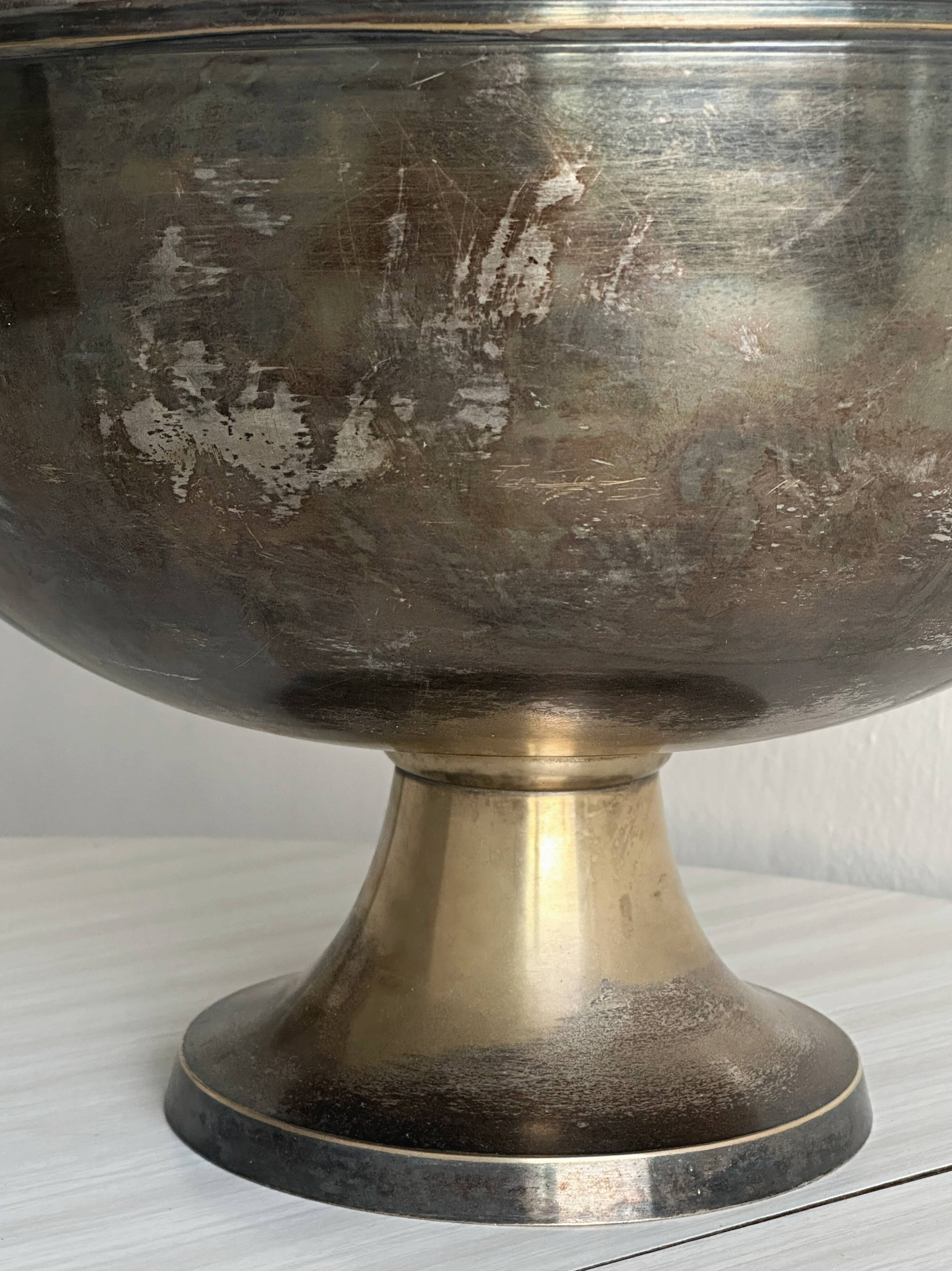 Large champagne bucket with patinated metal swan handles.