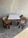 Mid-century white laminate dining table with dark wood base and 4 beige upholstered chairs