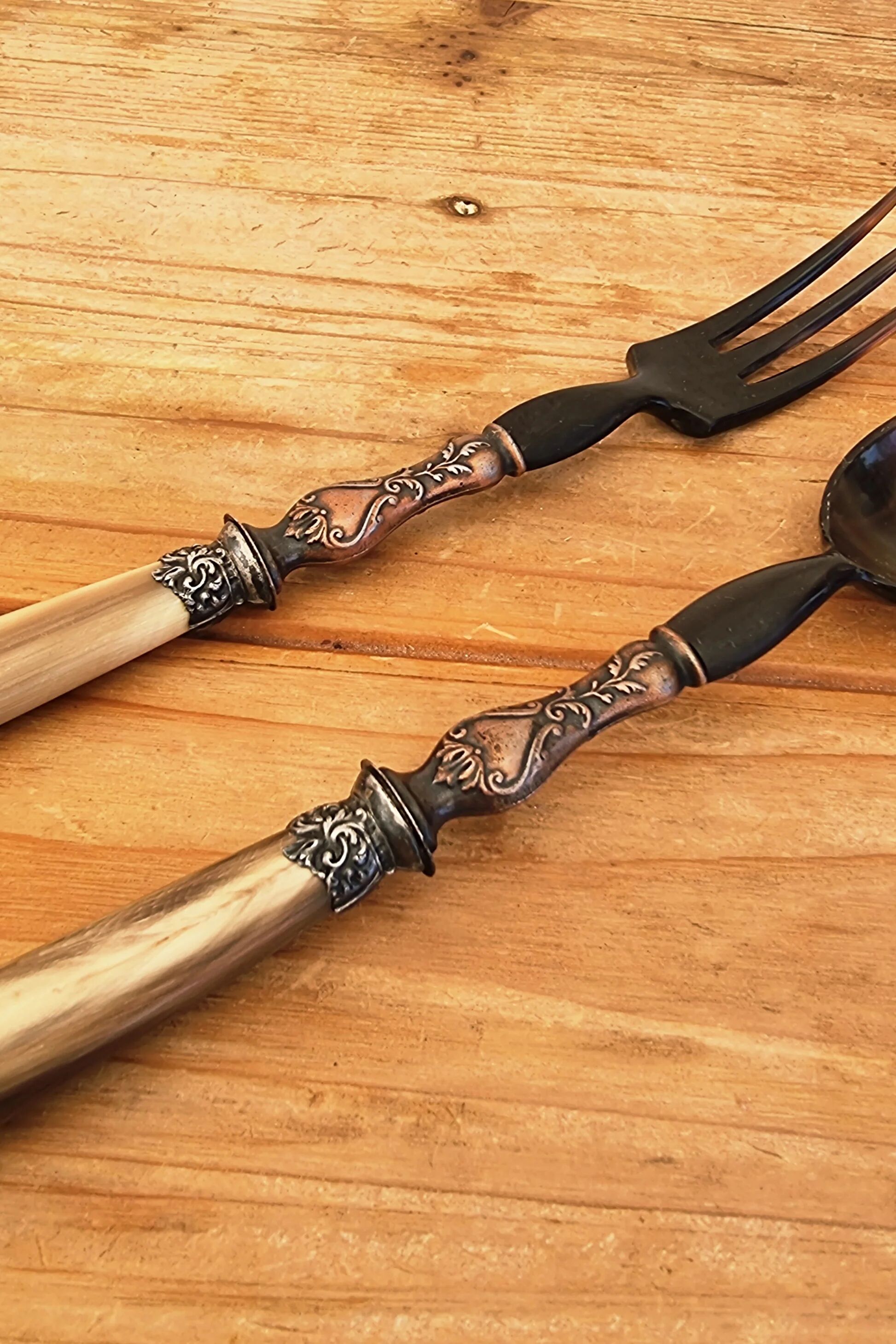 Vintage serving cutlery in horn and wrought metal