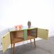 Vintage green DDR cabinet, model Libelle with glass top, slanted legs.