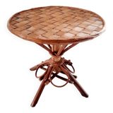 Old bamboo/rattan table with woven palm leaves.
