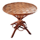 Old bamboo/rattan table with woven palm leaves.