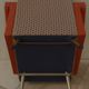 Vintage rockabilly retro armchair in orange faux leather and fabric.