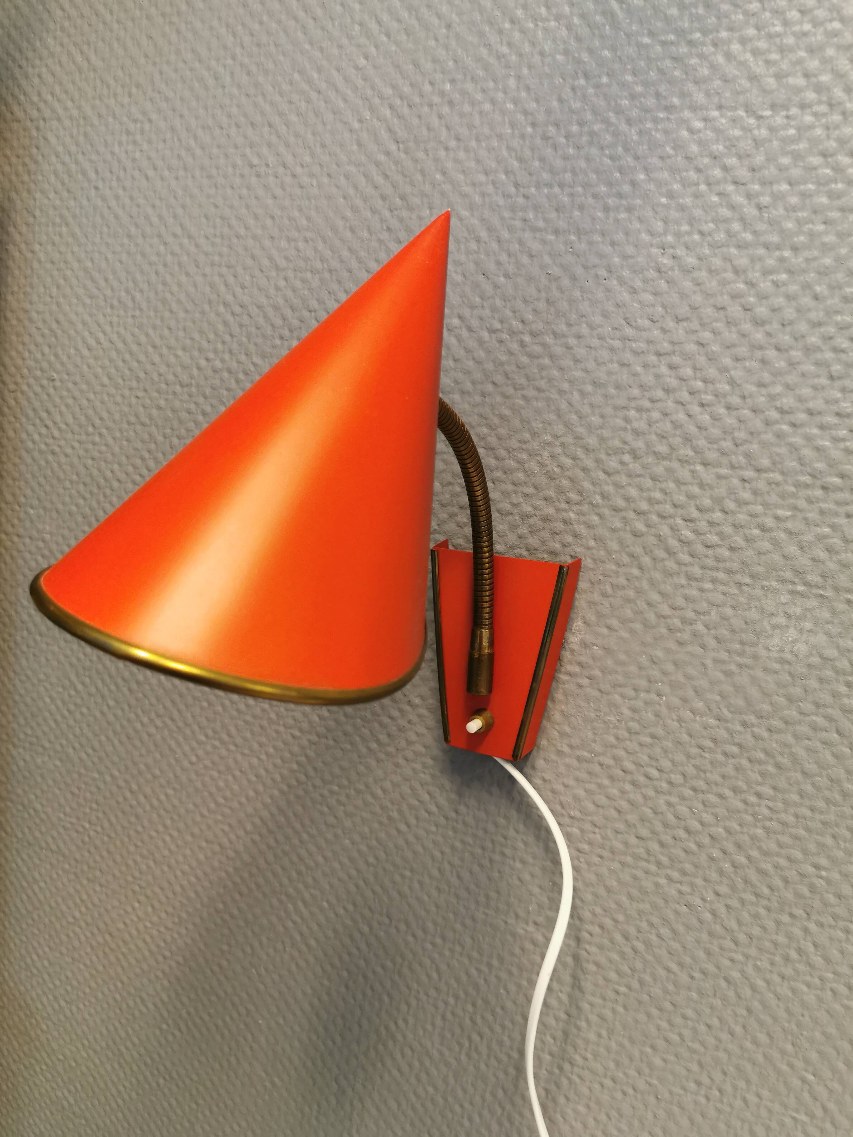 Danish red lacquered wall light with brass details. Estimated 1980s