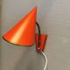 Danish red lacquered wall light with brass details. Estimated 1980s