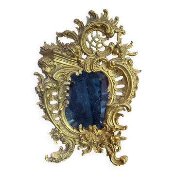 Beveled mirror in gilt bronze