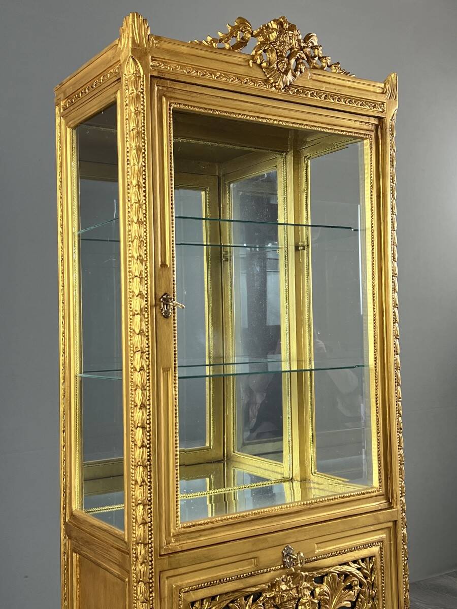 Carved and gilded wooden display cabinet, Louis XVI style, 20th century.