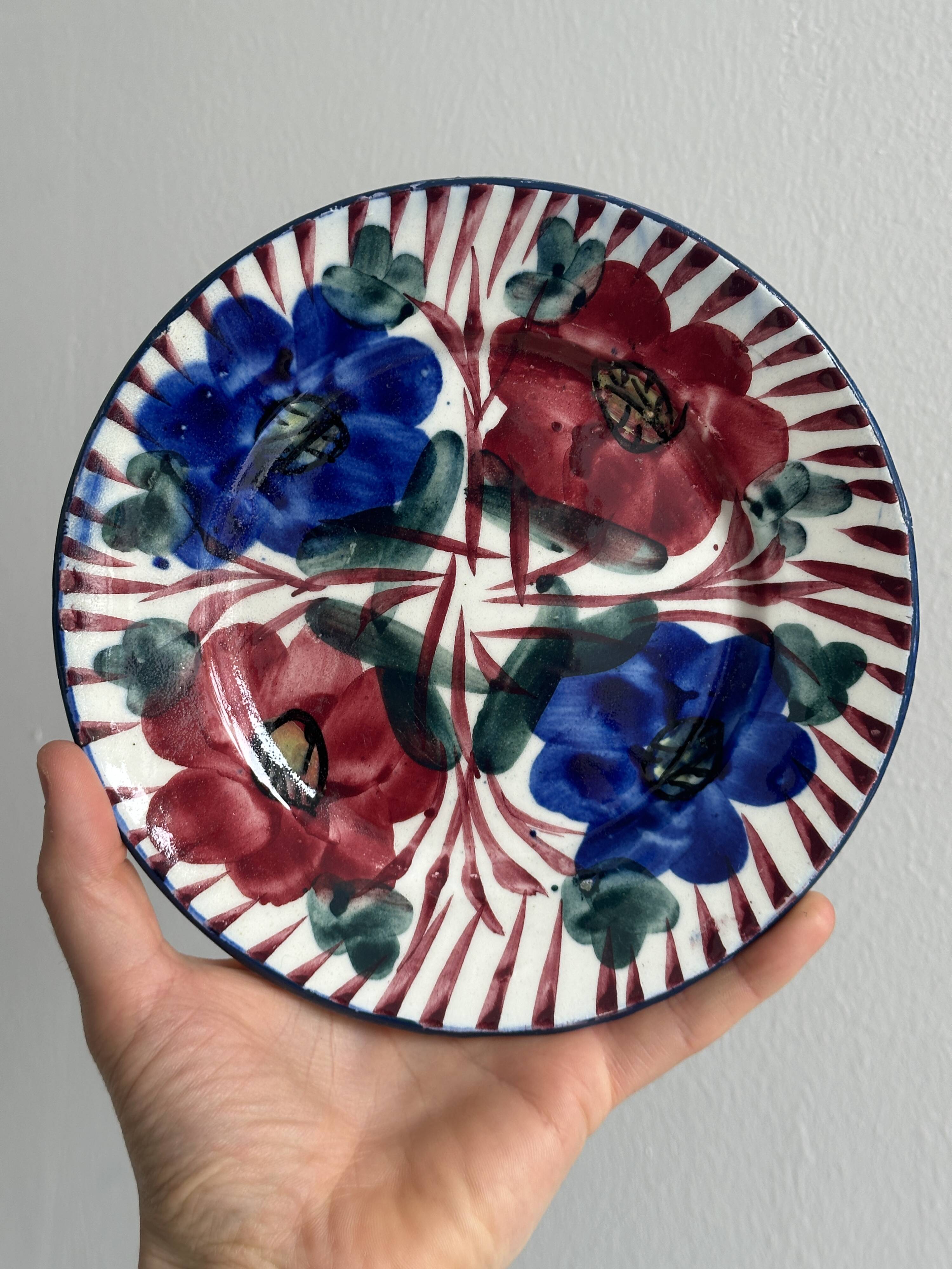 Pair of decorative ceramic plates with floral motifs.