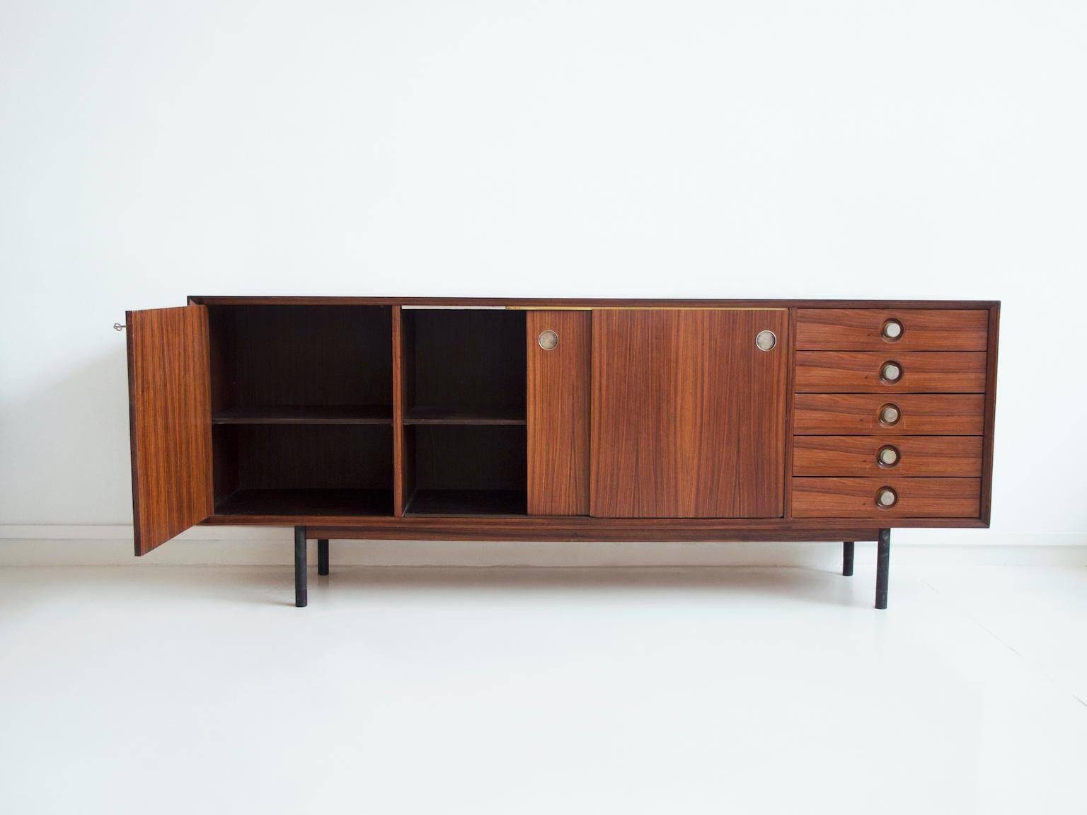 Wooden sideboard with sliding door and white drawers, around 1960.