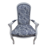 Voltaire style armchair covered in floral fabric in quality aged wood