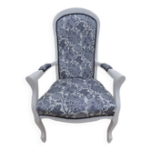 Voltaire style armchair covered in floral fabric in quality aged wood