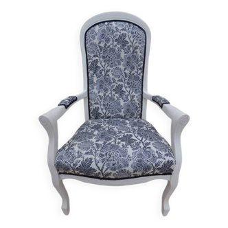 Voltaire style armchair covered in floral fabric in quality aged wood