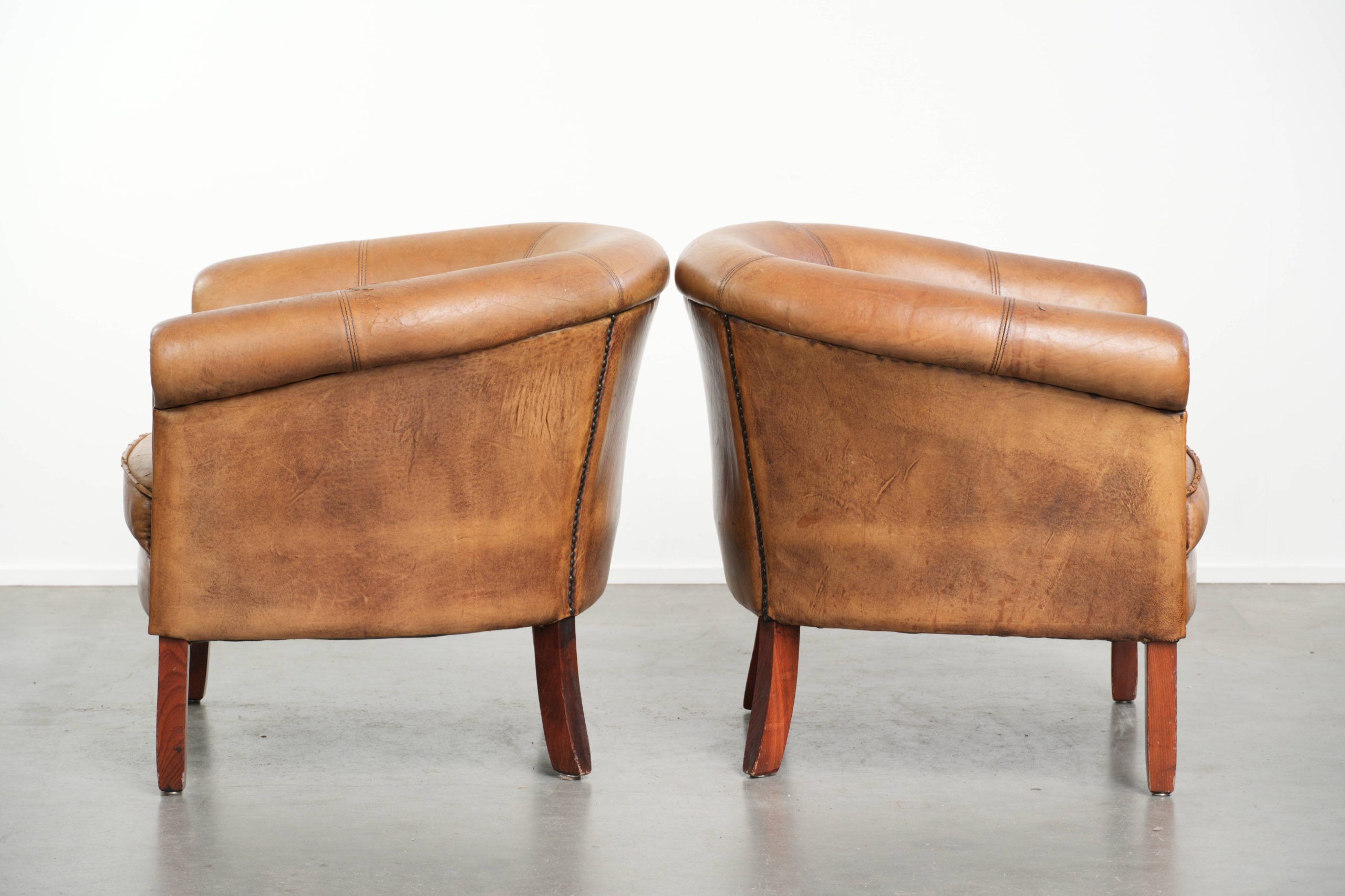 Set of two vintage sheepskin club armchairs with a beautiful light colour