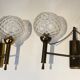 Pair of brass wall lights with glass globes. Around 1970.