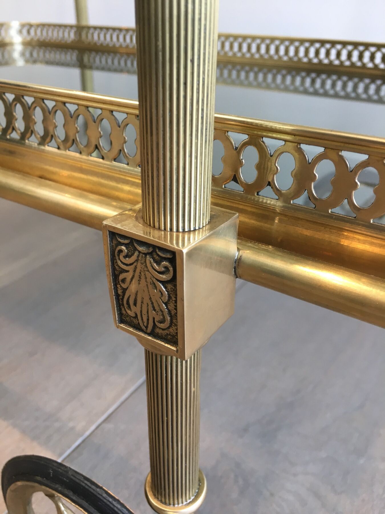 Neoclassical style rolling table in brass with blue glass tops