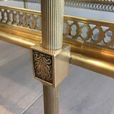 Neoclassical style rolling table in brass with blue glass tops