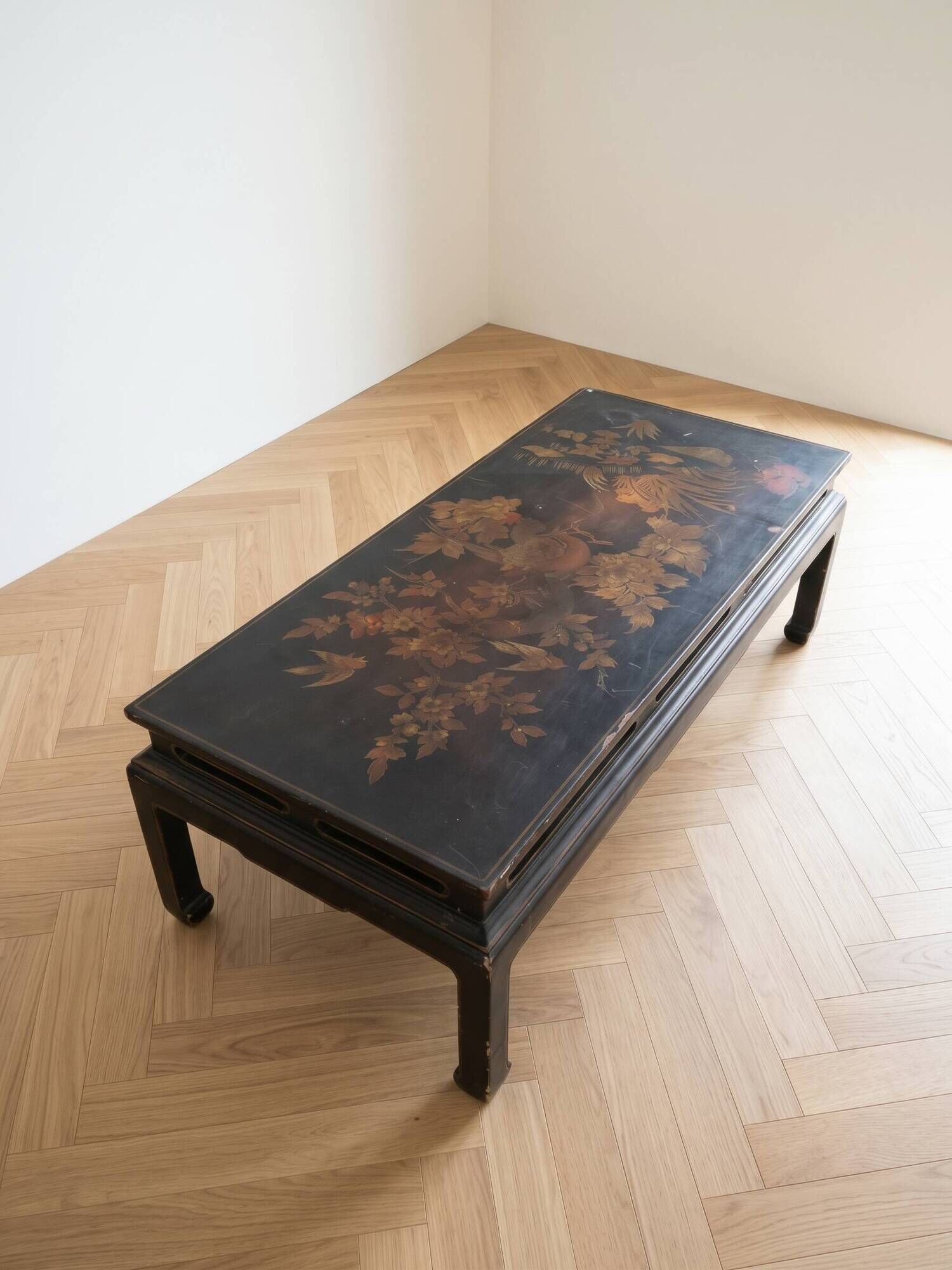 Antique Chinese coffee table in black and gold painted wood.