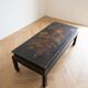 Antique Chinese coffee table in black and gold painted wood.