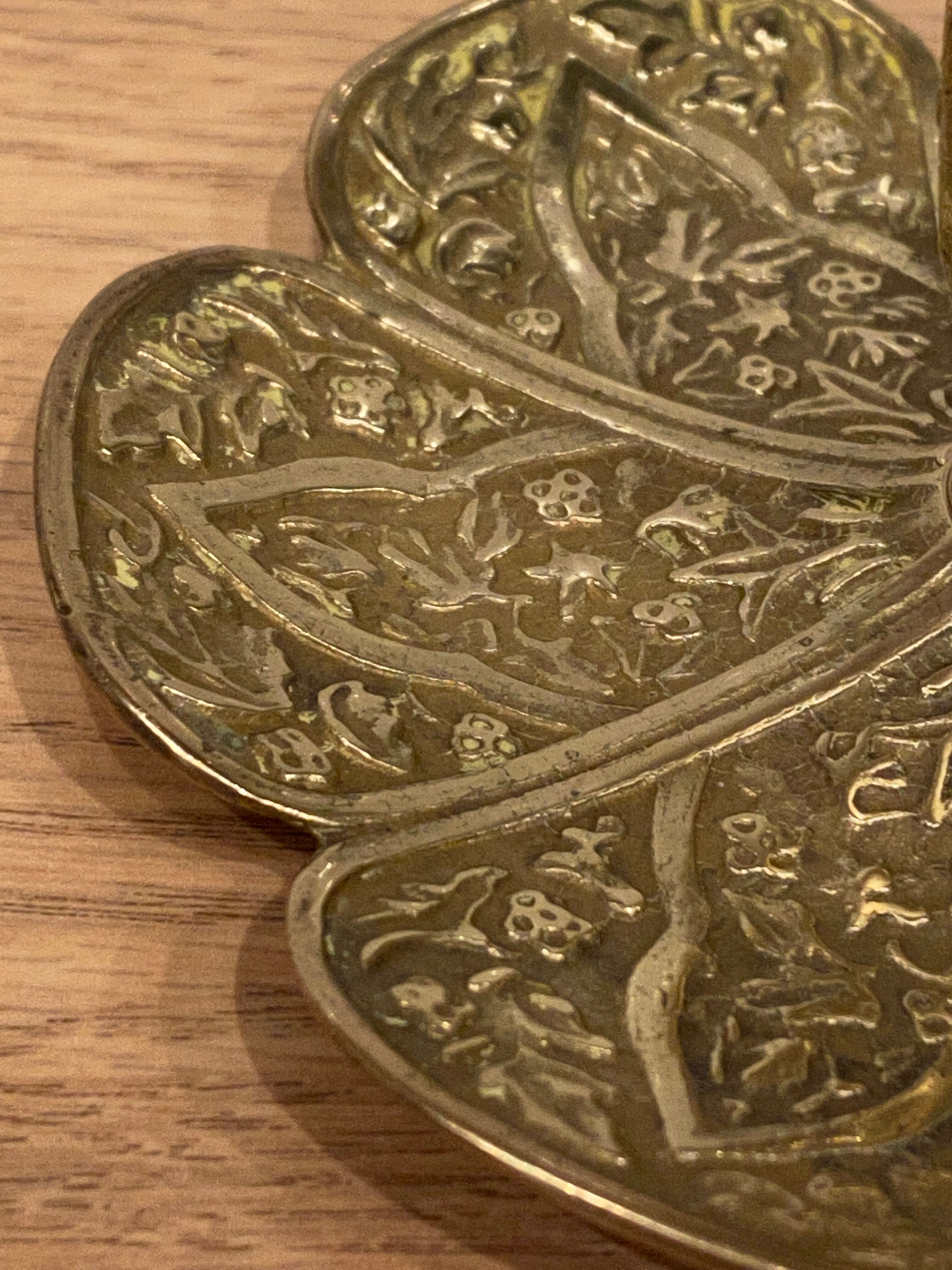 Brass candle holder on frame