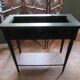 Vintage planter on wheels made of oak, repainted in black.