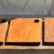 Small rectangular teak monoxyle cutting board with a circular handle.