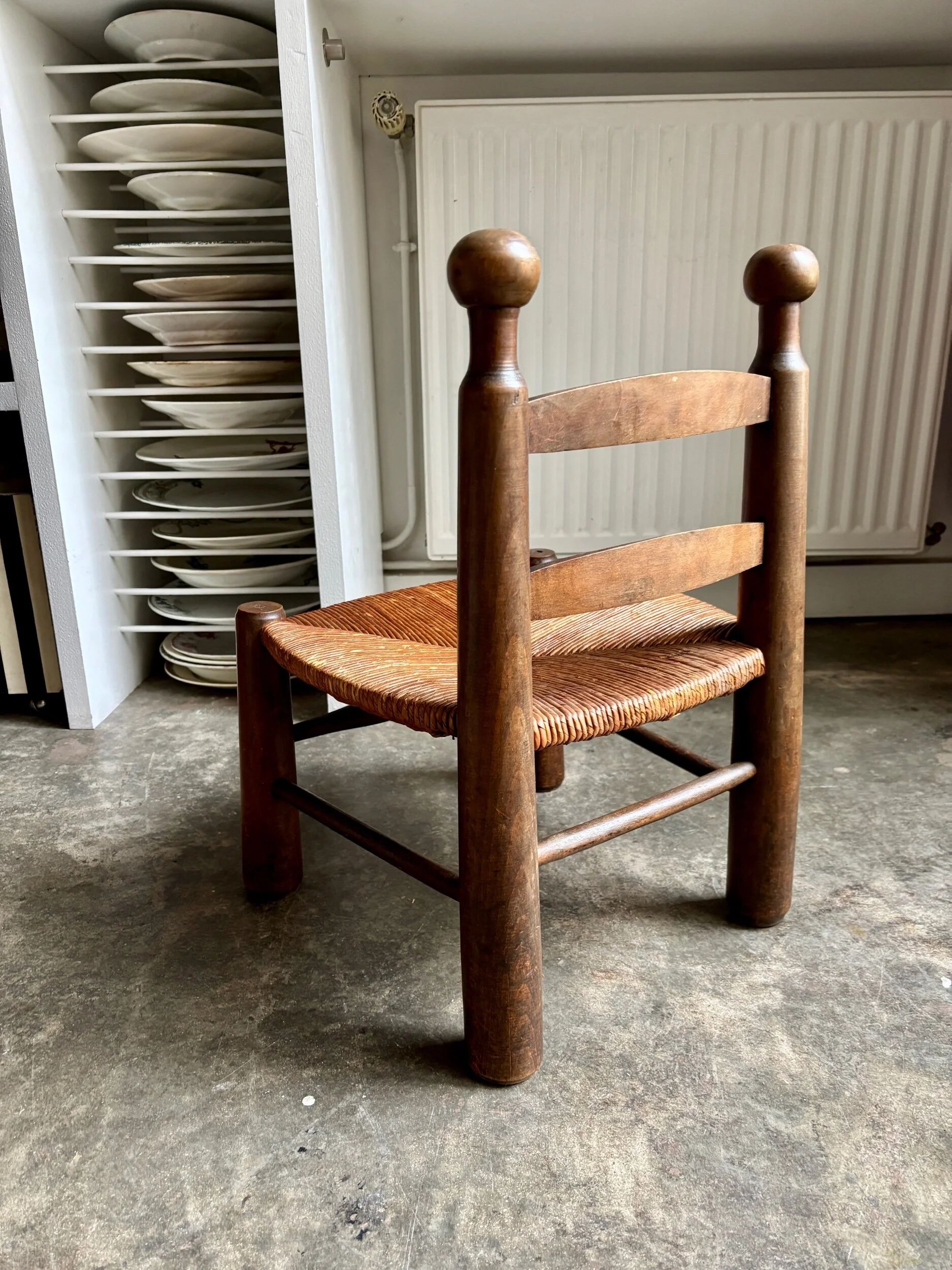 Brutalist low chair in dark wood and straw no. 2