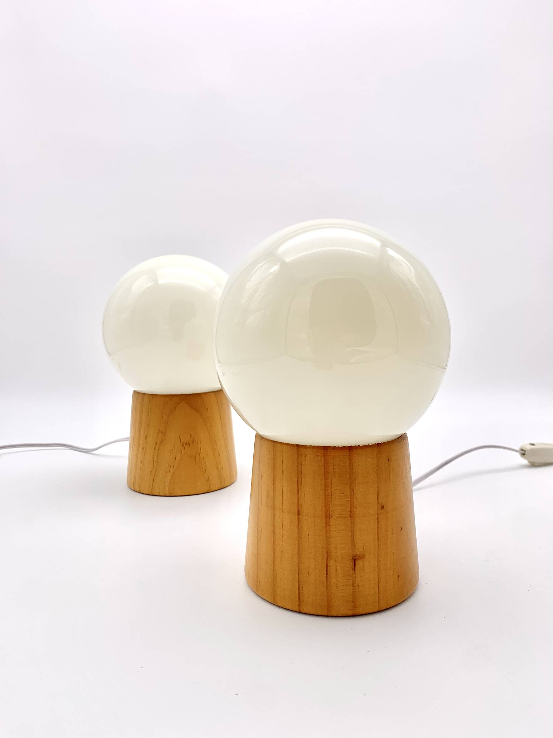 Pair of lamps with wooden base and glass globe, 1970s